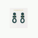 A pair of Organic Three Tier Clay Earrings in Evergreen by JaxKelly rests on a white card labeled "JaxKelly.