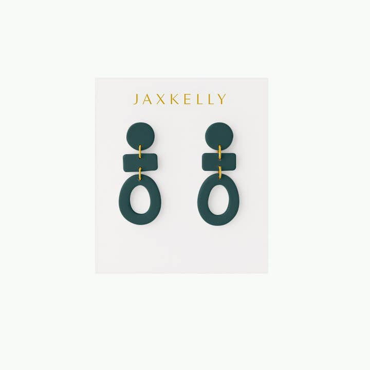 A pair of handcrafted Organic Three Tier Clay Earrings in Evergreen from JaxKelly, shown on a white card with the brand’s gold logo.