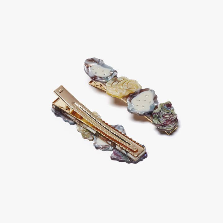 The Winona Irene Oyster Shell Acetate Alligator Hair Clip with Rhinestones is a charming accessory, featuring decorative metal and a shimmering design, displayed on a white background.