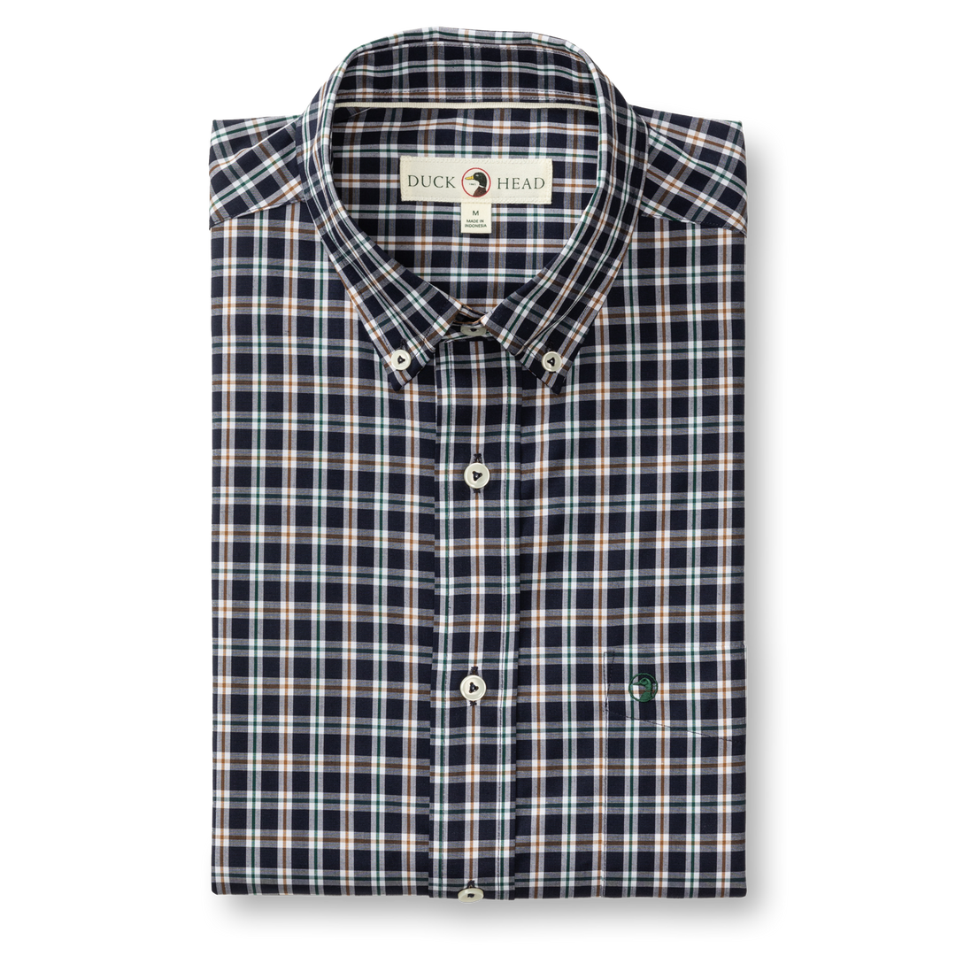 The Duck Head Performance Poplin Sport Shirt is a folded navy, white, and red plaid button-down with a collar, featuring a "Duck Head" label and a small embroidered chest logo.
