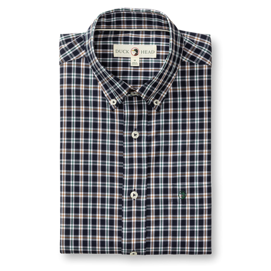 The Duck Head Performance Poplin Sport Shirt is a folded navy, white, and red plaid button-down with a collar, featuring a "Duck Head" label and a small embroidered chest logo.