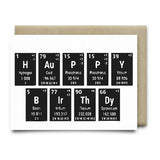 The Periodic Birthday A2 card by Anvil Cards spells "Happy Birthday" with periodic table elements on black tiles, each showing the symbol, name, atomic number, and weight. Hand-drawn design printed on sustainable linen paper.