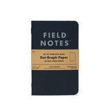 A Field Notes Pitch Black Notebook 3-Pack, each with 48 dot-graph pages, is shown wrapped in a brown paper band around the cover.