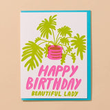 The Plant Lady Letterpress Birthday Card by And Here We Are features a green potted plant and “Happy Birthday Beautiful Lady” in pink and yellow—perfect for the plant lover in your life.