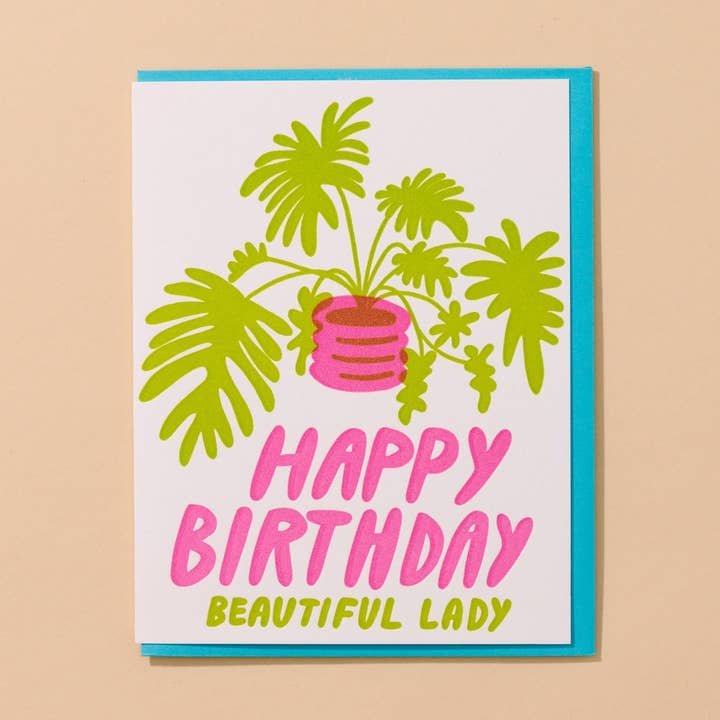 The Plant Lady Letterpress Birthday Card by And Here We Are features a green potted plant and “Happy Birthday Beautiful Lady” in pink and yellow—perfect for the plant lover in your life.