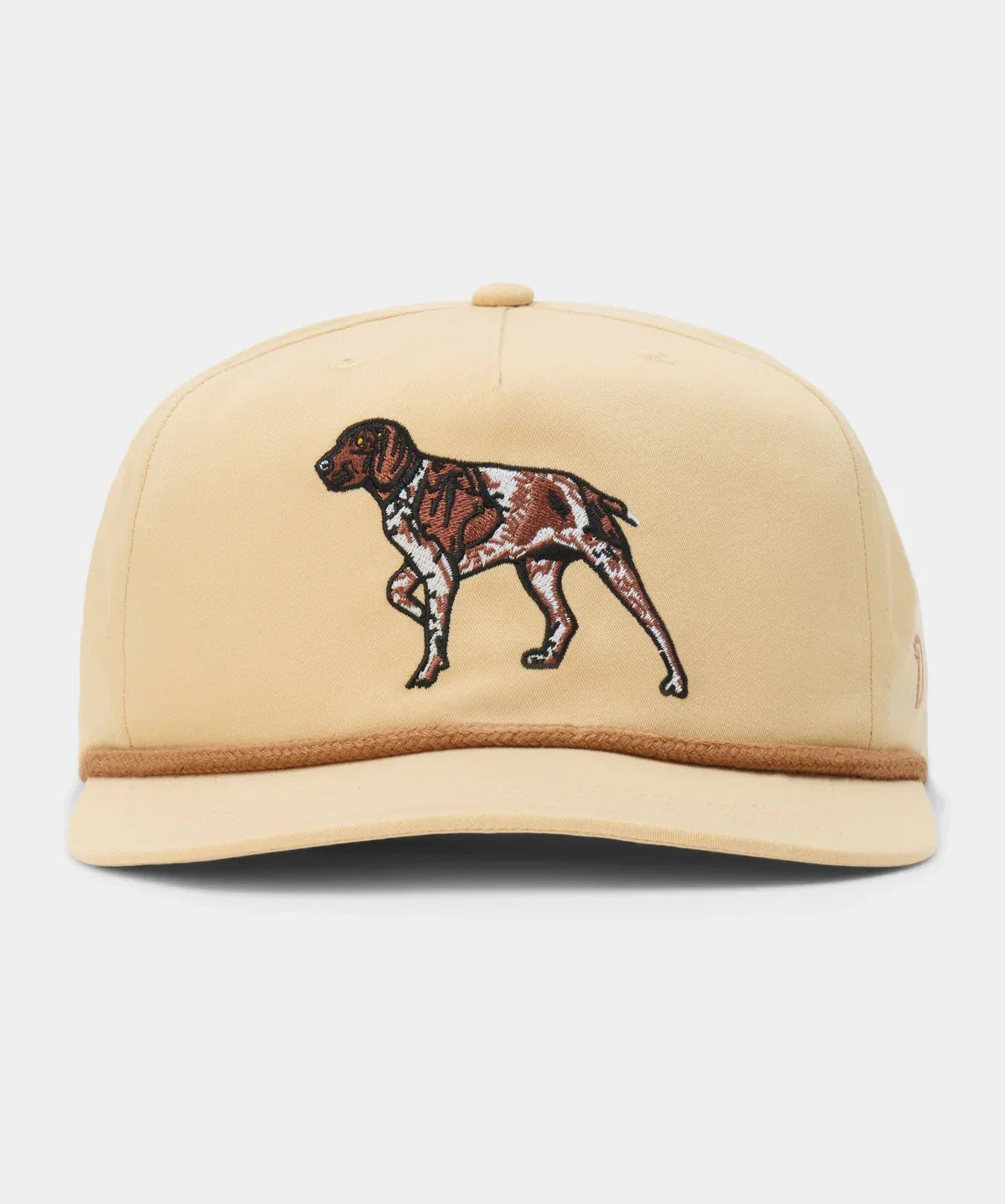 The Pointer Hat by Duck Camp is a beige adjustable cap with an embroidered brown and white dog on the front, made from a comfortable polyester shell.