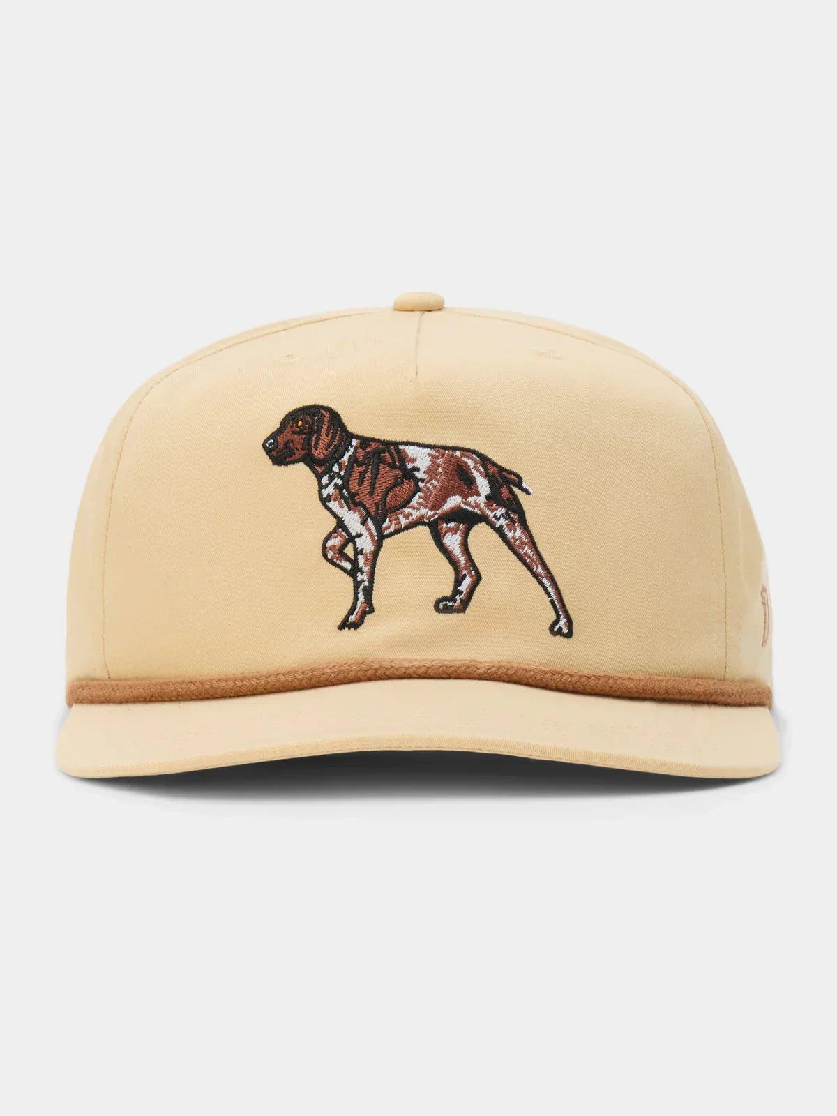 The Pointer Hat by Duck Camp features a tan base with a brown and white embroidered dog on the front, brown trim on the brim, and an adjustable snapback for a perfect fit.