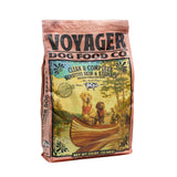 A 23 lb (10.4 kg) bag of Voyager Dog Food Co. "Clean & Complete Sensitive Skin & Stomach," vet-created for sensitive dogs and copper storage disease, featuring canoeing dogs, by Voyager Dog Food Co.