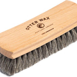 The Otter Wax Premium Horsehair Shoe Brush features a wooden handle and gray bristles, labeled "Otter Wax Portland, Oregon 100% Horsehair.