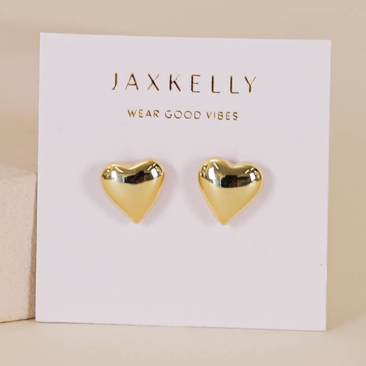 A pair of tarnish-free Puffed Gold Heart Earrings by JaxKelly, displayed on a white card labeled "JaxKelly Wear Good Vibes.