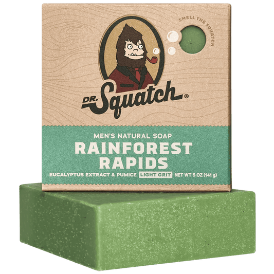 Dr. Squatch Rainforest Rapids Soap features a green bar with eucalyptus extract and pumice for a refreshing, invigorating cleanse, shown in brown and green packaging.