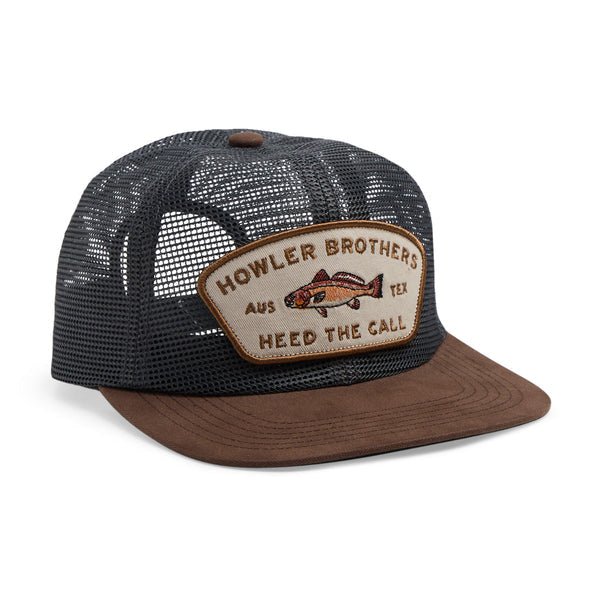 The Redfish Feedstore Snapback by Howler Brothers is a black mesh trucker hat with a brown brim, adjustable snapback closure, and a front patch that says "Howler Brothers AUS TEX Heed The Call" plus an embroidered fish graphic.