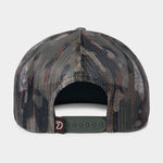 The Lucky Deer Hat by Duck Camp is a mesh-back camouflage baseball cap with a green adjustable snapback closure and a small brown tag, shown from the rear.