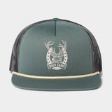 The Lucky Deer Hat by Duck Camp is a green trucker hat with a mesh back, cream rope detail, and a white antler-horseshoe "DUCK CAMP" logo on the front. Features an adjustable snapback for the perfect fit.