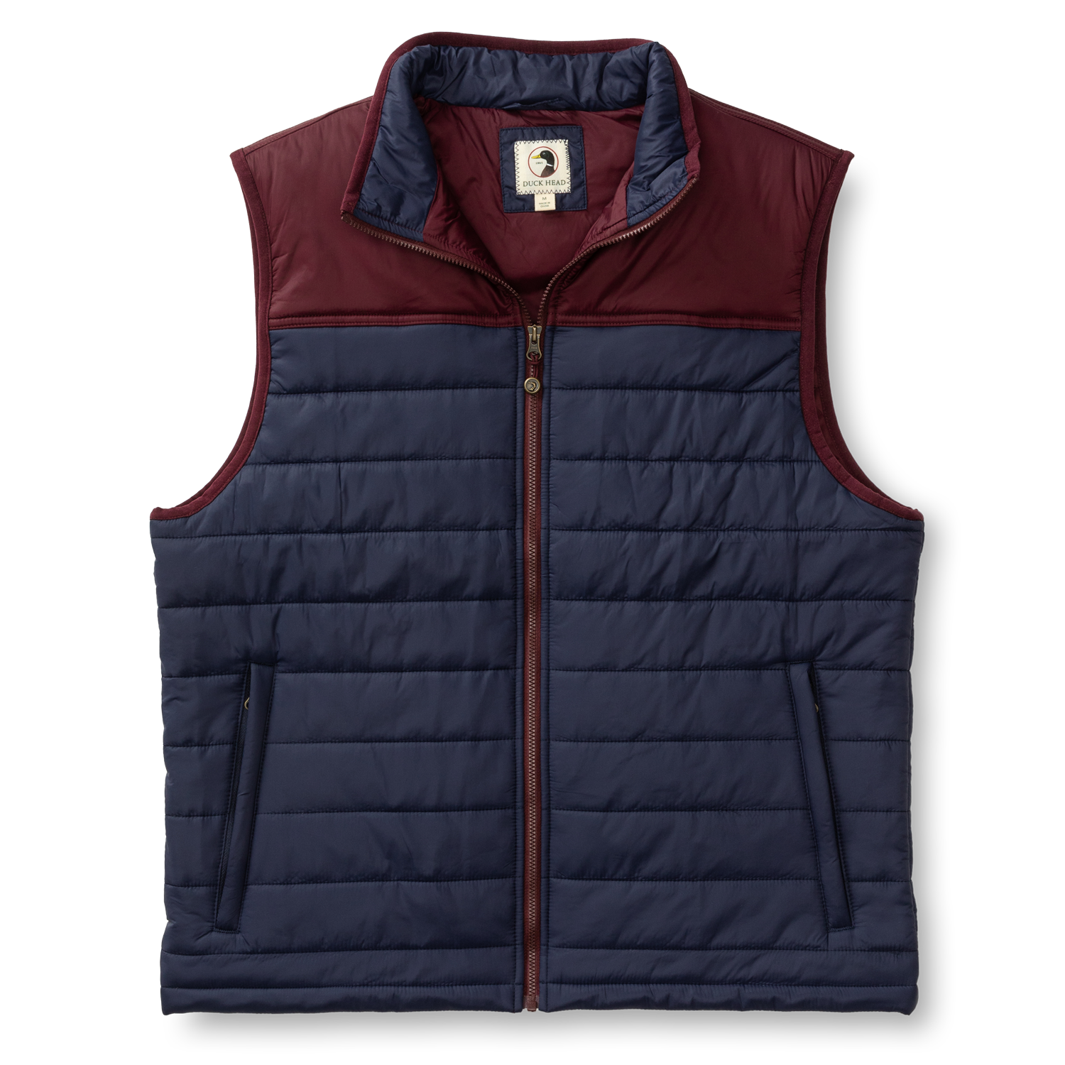 The Duck Head Ridgeland Performance Quilted Vest is lightweight and sleeveless with PrimaLoft insulation, a navy body, maroon yoke and collar, zip front closure, and is shown on a plain white background.