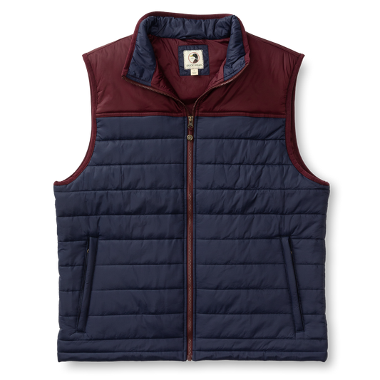 The Duck Head Ridgeland Performance Quilted Vest is lightweight and sleeveless with PrimaLoft insulation, a navy body, maroon yoke and collar, zip front closure, and is shown on a plain white background.