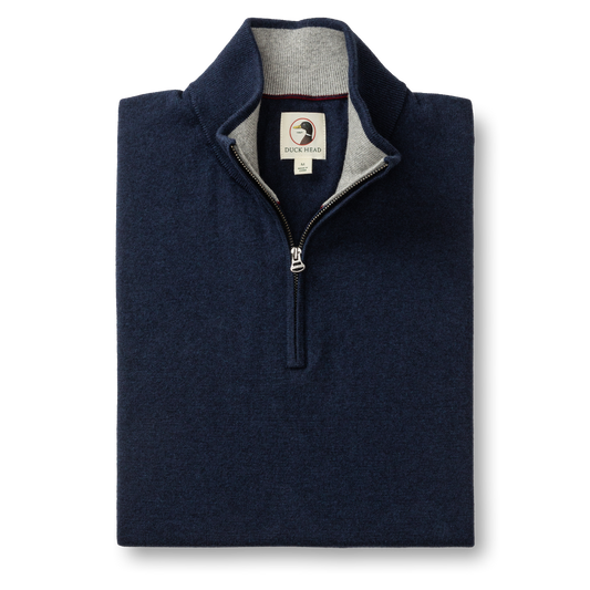 The Duck Head Ridley 1/4 Zip Sweater in navy features a standing collar, gray inner lining, and is machine washable—blending classic style and convenience for everyday wear.