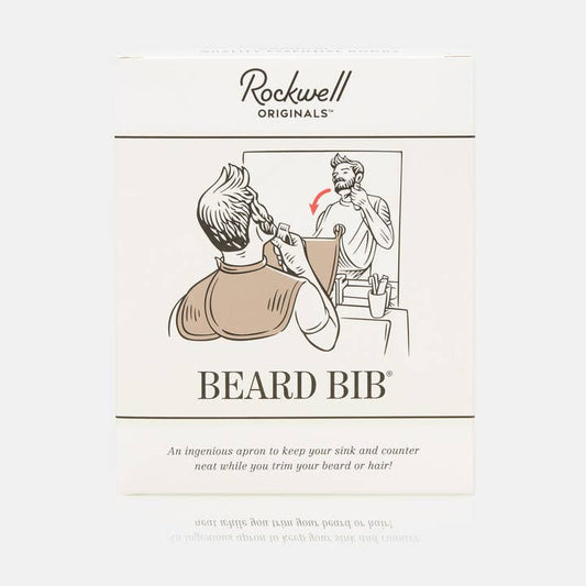 A Rockwell Beard Bib by Rockwell Razors, shown with a man using the grooming apron in front of a mirror to catch beard trimmings.