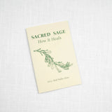 The Sacred Sage by Taos Herb Co. features a green sage design on a cream cover and explores healing with sage, displayed on a white textured surface.