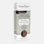 The Rockwell Razors Safety Razor | R1 is a single blade razor in gunmetal chrome, visible inside plastic-free packaging with branded details on the box—designed for a smooth shave.