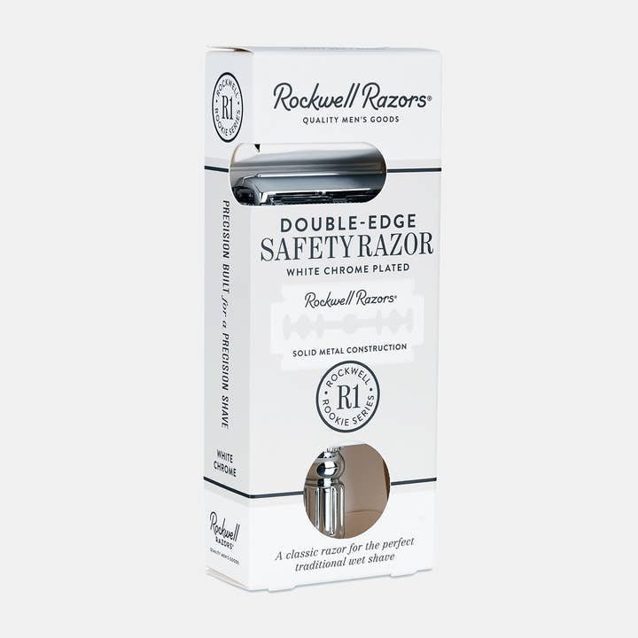A white and silver box labeled "Rockwell Razors Safety Razor | R1" displays a chrome-plated single blade razor, designed for a smooth, eco-friendly shave with a plastic-free grooming experience.