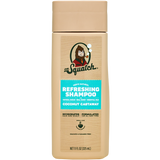 A tan bottle of Dr. Squatch Shampoo in Coconut Castaway scent, enriched with oat protein and toasted coconut aroma, features the Dr.Squatch logo and product details on the front label.