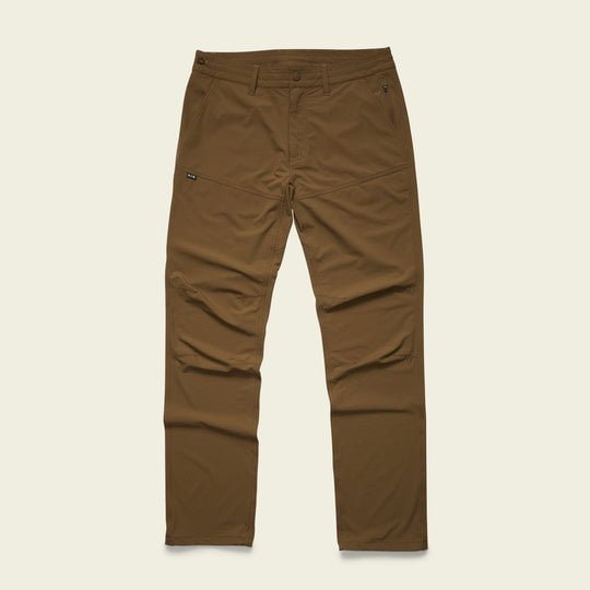 The Shoalwater Tech Pants by Howler Brothers are brown, straight-leg pants with front and side pockets, made from smooth, lightweight 4-way stretch fabric, shown flat on a plain background.