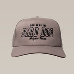 The Ballad of the Bird Dog Shop Hat | Arizona to Texas is a gray trucker hat with black embroidered "Ballad of the Bird Dog Arizona-Texas" text on the front, shown on a plain beige background.