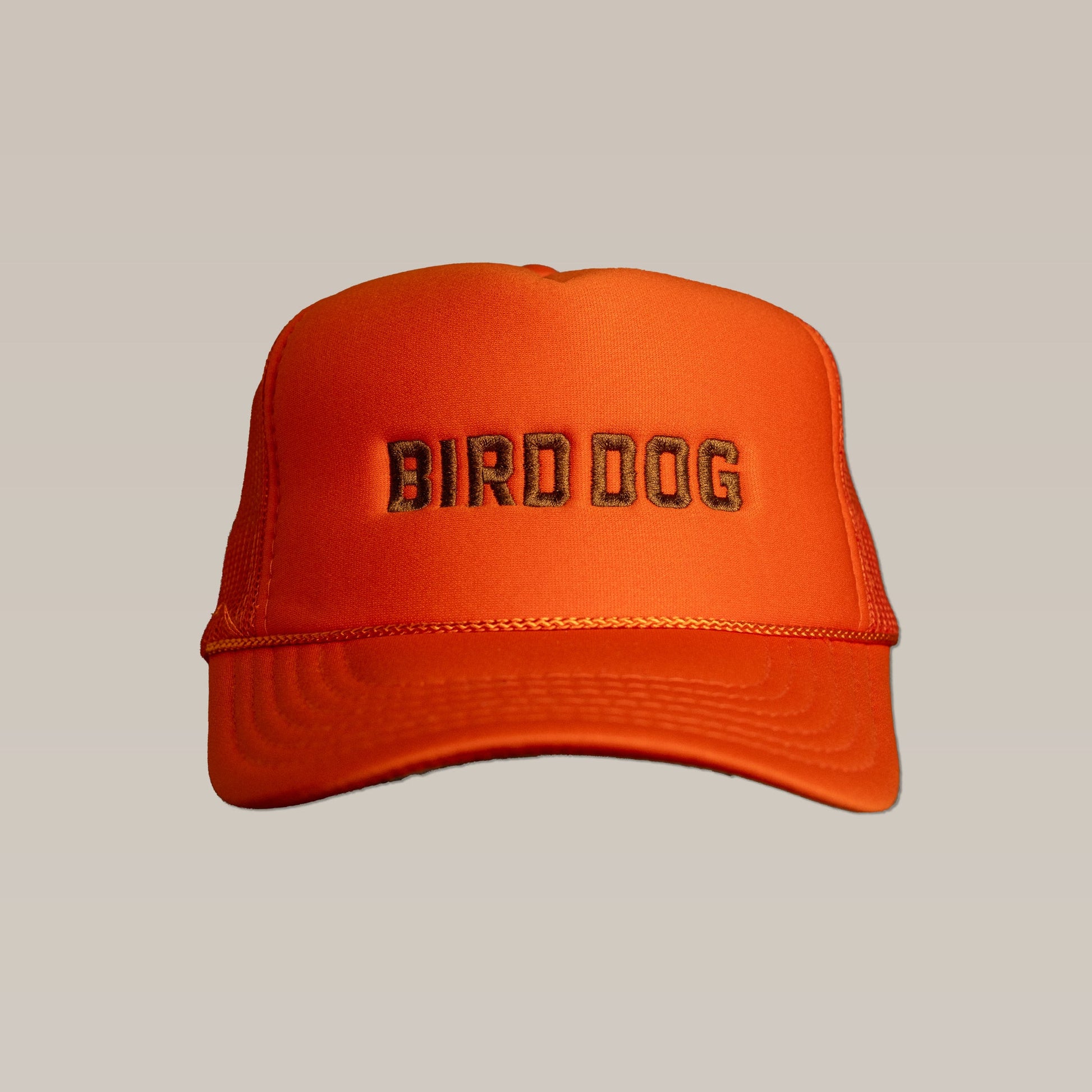 The Ballad of the Bird Dog "Shop Hat | Bird Dog Honor" features orange mesh and "BIRD DOG" embroidered in black on the front, shown against a plain beige background.