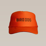 The Ballad of the Bird Dog Shop Hat features an orange mesh back and "BIRD DOG" embroidered in black on the front, shown against a plain beige background.