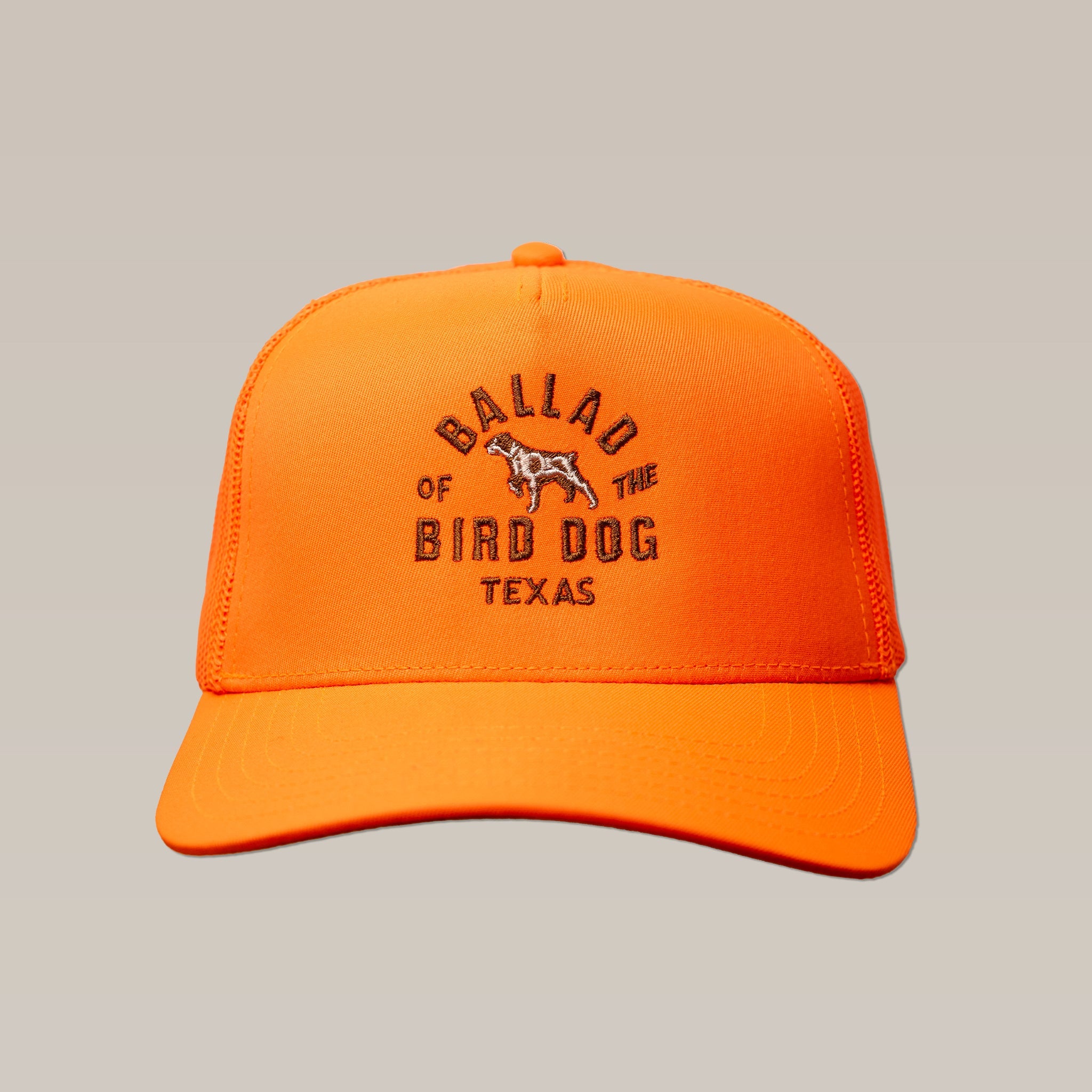 The Shop Hat | Field Companion by Ballad of the Bird Dog is a bright orange baseball cap featuring "Ballad of the Bird Dog Texas" and a bird dog graphic embroidered on the front.