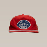 The Shop Hat | Home Base by Ballad of the Bird Dog is a red hat with a blue and white patch reading "BALLAD of the BIRD DOG, 100 E ALAMO ST, BRENHAM, TX"—a standout small business hat for showing community spirit.