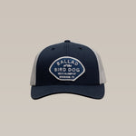 Show your local pride with the Shop Hat | Home Base by Ballad of the Bird Dog. This navy and gray hat features a front patch reading "Ballad of the Bird Dog, 100 E Alamo St, Brenham, TX"—perfect headwear for your community spirit.