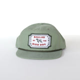 The Ballad of the Bird Dog Shop Hat | Neon Revival features a light green hue, a classic logo patch with "BALLAD OF THE BIRD DOG" and a small dog illustration, inspired by downtown Brenham style.