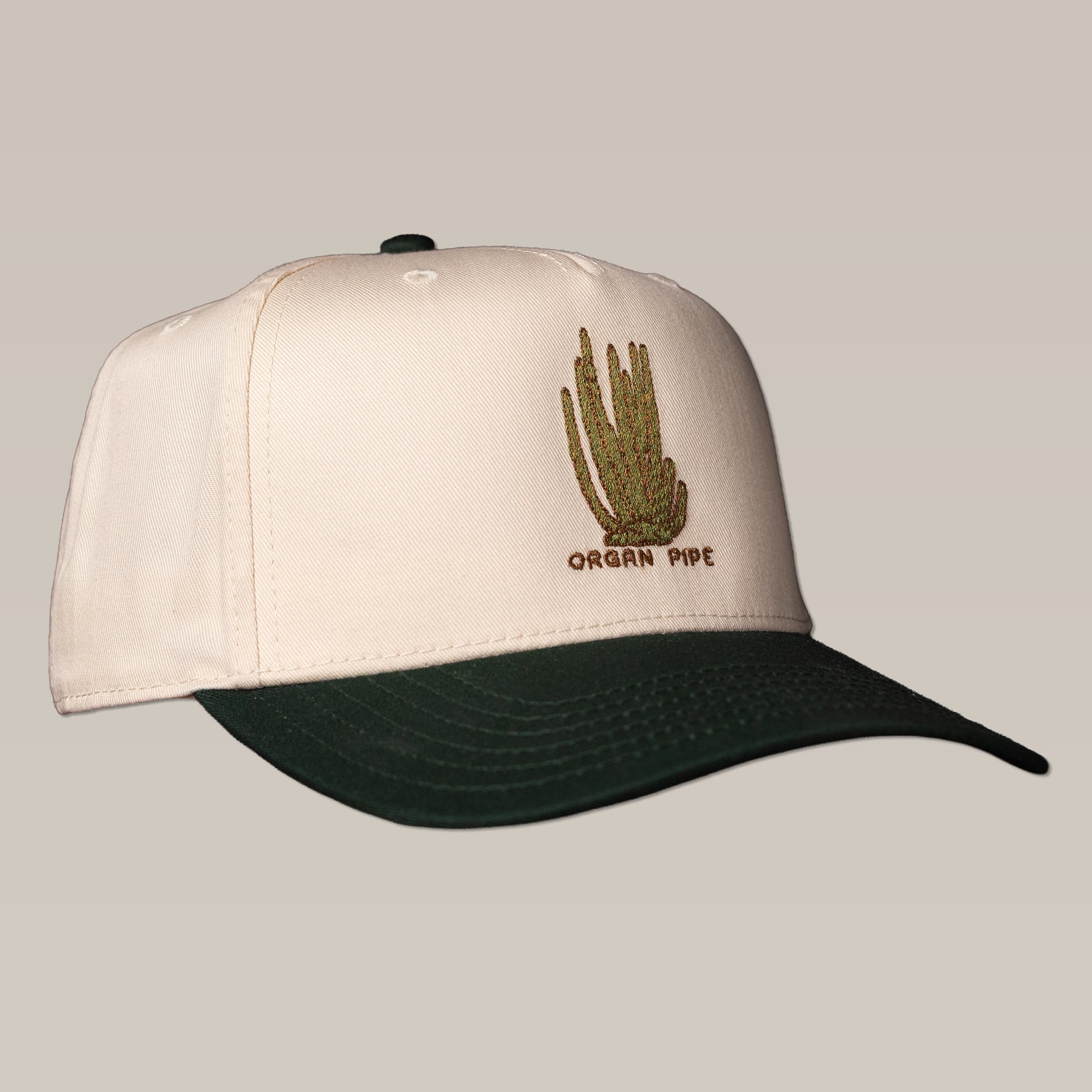 The Ballad of the Bird Dog Shop Hat | Organ Pipe features cream and dark green colors, an embroidered cactus, and "Organ Pipe" text inspired by the iconic Organ Pipe Cactus of the Southwest.