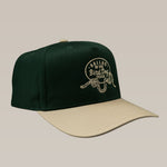 The Ballad of the Bird Dog Shop Hat features a green and beige Rattlesnake Oval Logo design, with "Ballad of the Bird Dog Texas" and a coiled rattlesnake graphic—perfect for fans of stylish snake-themed hats.