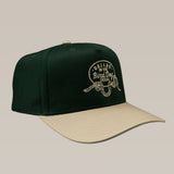 The Ballad of the Bird Dog Shop Hat features a green and beige Rattlesnake Oval Logo design, with "Ballad of the Bird Dog Texas" and a coiled rattlesnake graphic—perfect for fans of stylish snake-themed hats.