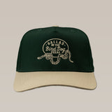Dark green and beige Shop Hat by Ballad of the Bird Dog featuring an embroidered Rattlesnake Oval Logo and "Ballad of The Bird Dog Texas" on the front.