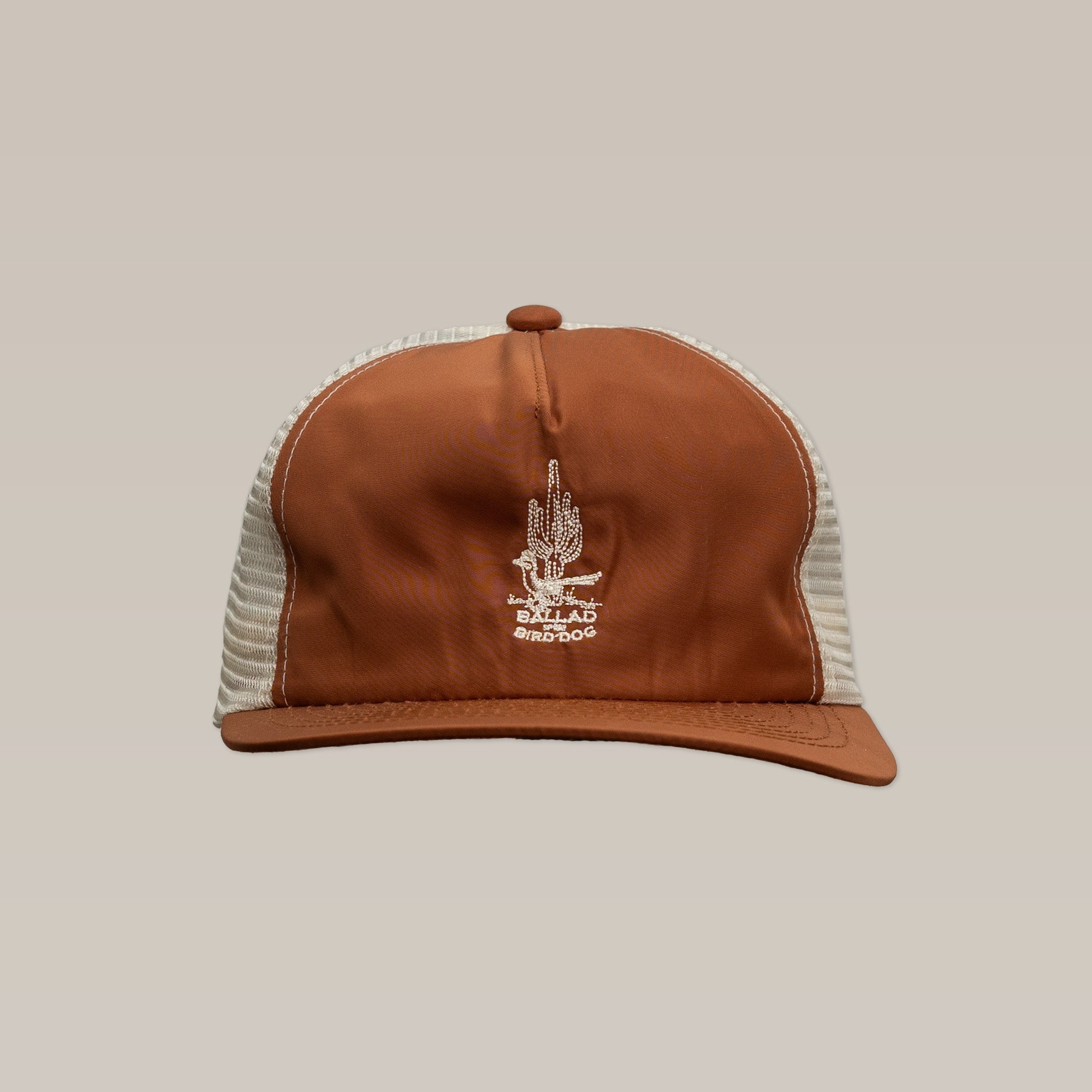 The Ballad of the Bird Dog Shop Hat | Roadrunner Saguaro features brown and white embroidery with a cactus and “Ballard Bridge” logo, displayed on a beige background—a perfect Southwest hat for any adventure.