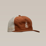 The "Shop Hat | Roadrunner Saguaro" by Ballad of the Bird Dog features brown and white mesh with a front embroidered logo, shown against a plain beige background.
