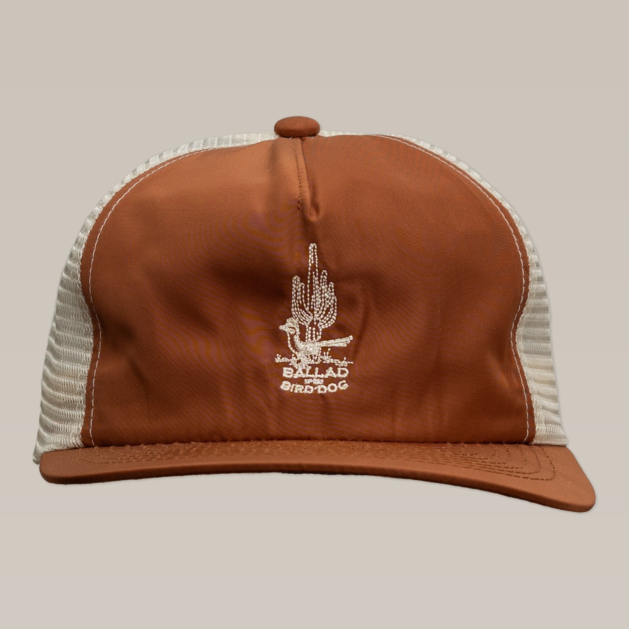 The "Shop Hat | Roadrunner Saguaro" by Ballad of the Bird Dog is a brown and beige mesh cap featuring a white embroidered cactus and "BALLAD BIRDDOG" on the front.