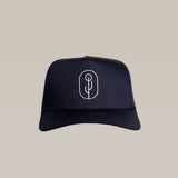 The Shop Hat | Simple Saguaro by Ballad of the Bird Dog is a black baseball cap with a white minimalist saguaro logo, embroidered on the front and shown against a plain beige background.