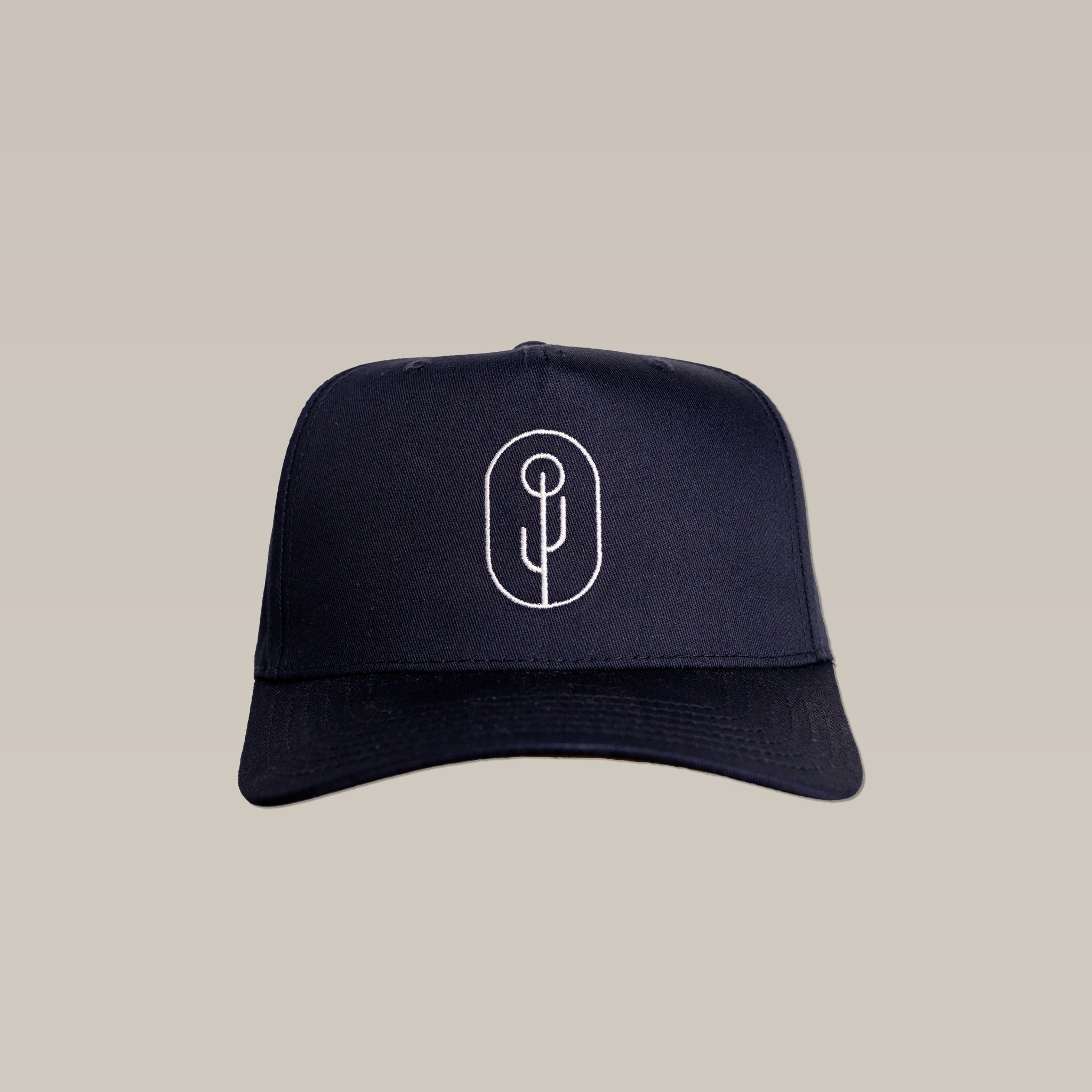 The Shop Hat | Simple Saguaro by Ballad of the Bird Dog is a black cap featuring a white minimalist saguaro logo embroidered on the front, shown against a plain beige background.