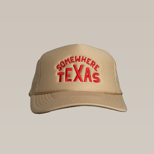The Shop Hat by Ballad of the Bird Dog is a beige snapback trucker with red "SOMEwhere TEXAS" text on the front—a signature Somewhere Texas style.