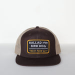 The Ballad of the Bird Dog Shop Hat features a brown and beige snapback with a front patch reading "Trust Your Gut Vintage Slate.
