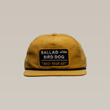 The Shop Hat | Trust Your Gut Vintage Slate by Ballad of the Bird Dog features a bold patch showcasing "TRUST YOUR GUT," adding vintage style and Brenham flair to your look.