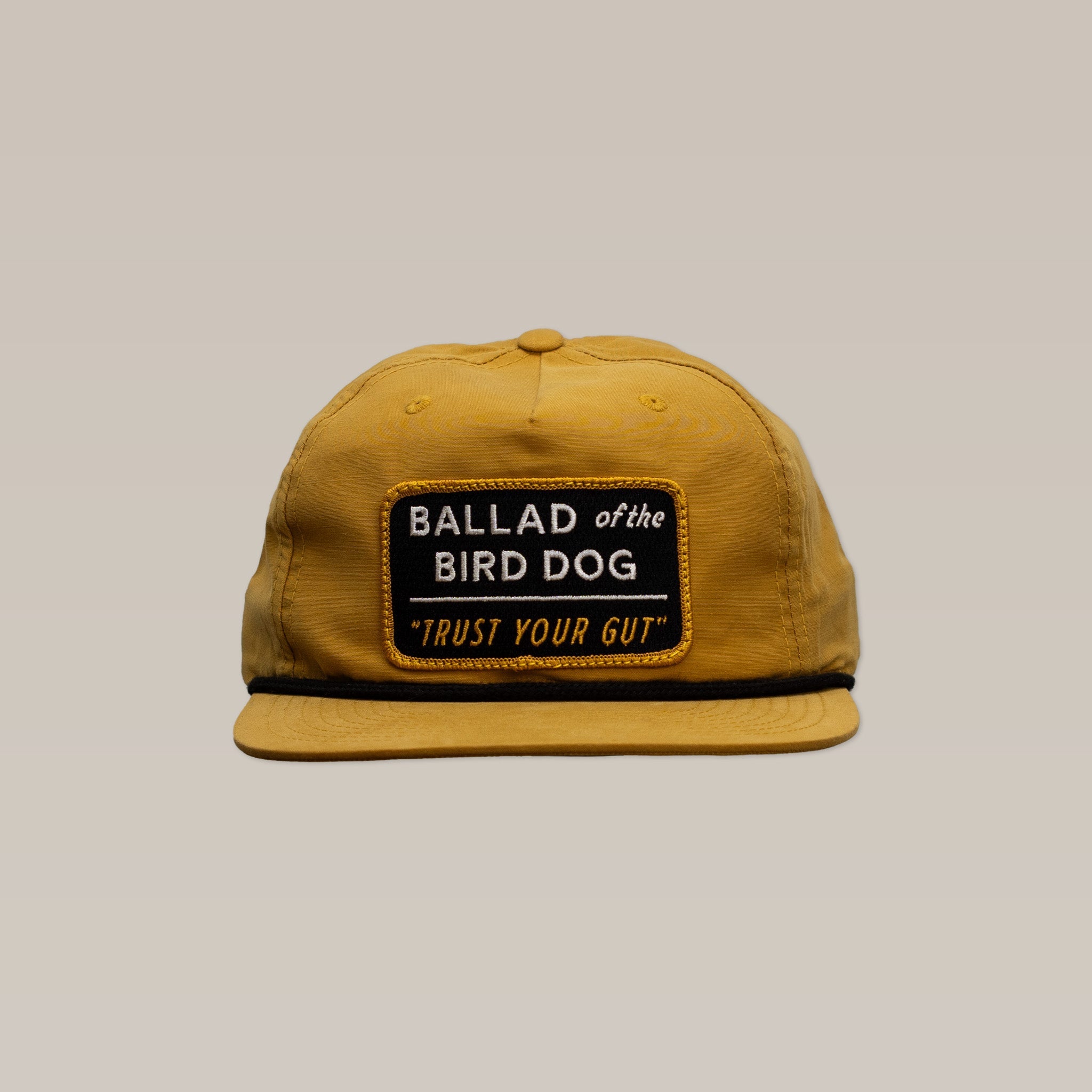 The Shop Hat | Trust Your Gut Vintage Slate by Ballad of the Bird Dog features a bold patch showcasing "TRUST YOUR GUT," adding vintage style and Brenham flair to your look.