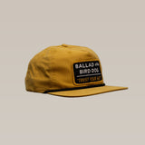 The Shop Hat | Trust Your Gut Vintage Slate by Ballad of the Bird Dog features a front patch reading “BALLAD of the BIRD DOG ‘TRUST YOUR GUT’”, making it the perfect casual accessory for true fans.