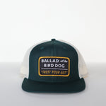 The Ballad of the Bird Dog Shop Hat features a dark green and white snapback with a front patch reading "Trust Your Gut"—a vintage slate style perfect for fans of the brand.