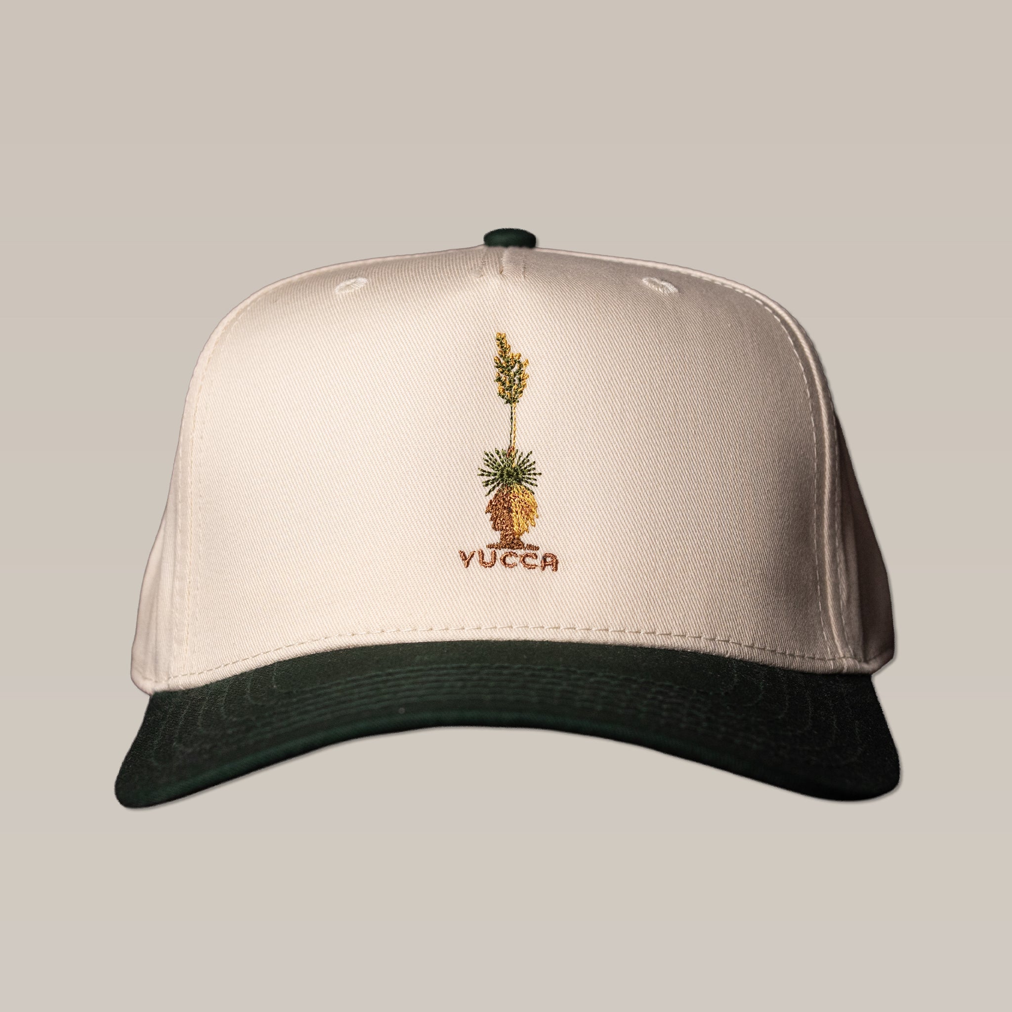 The Shop Hat | Yucca by Ballad of the Bird Dog features a cream and black design with an embroidered yucca plant and "YUCCA" on the front—a stylish pick from their Cactus Series for casual wear.